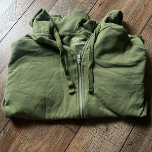 Cute green jacket, with a slight fuzzy inside. With hoodie strings